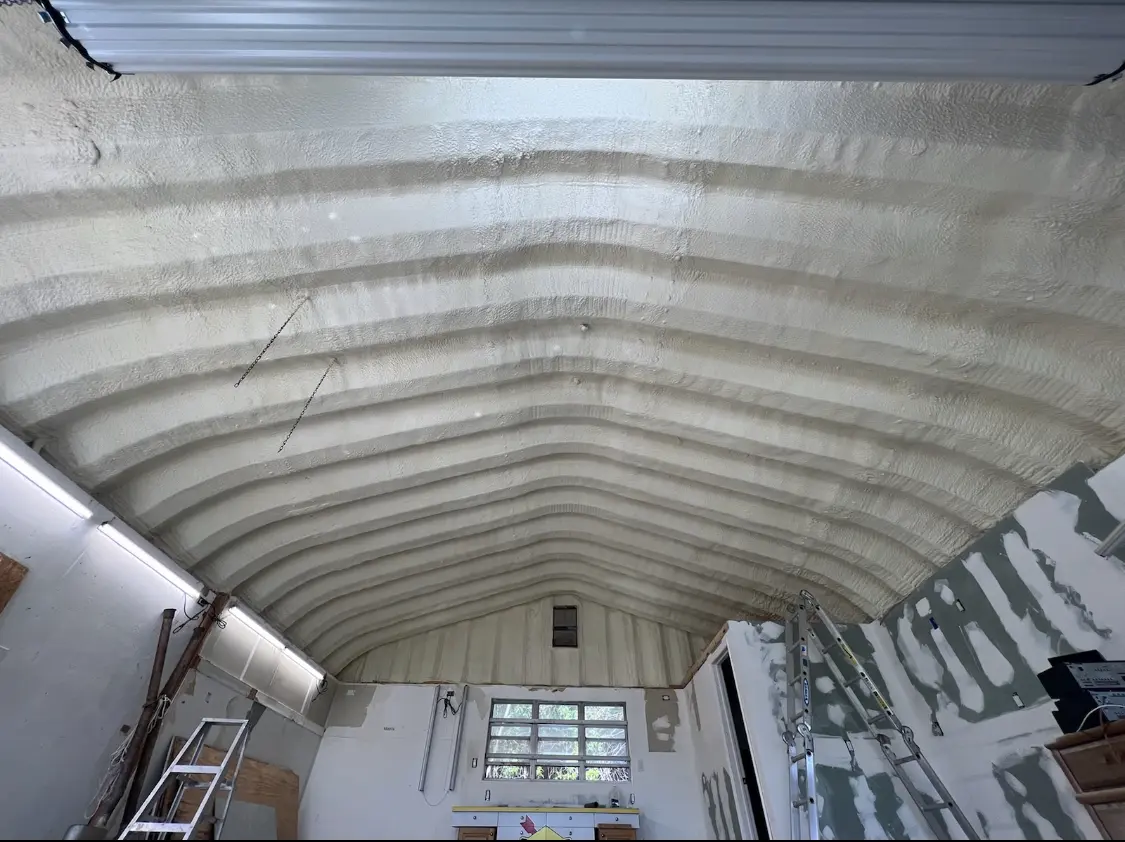 Spray polyurethane foam applied to the underside of a metal roof deck in Barre